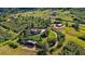 Expansive aerial view of the property with a home, outbuildings, and winding driveway at 1380 Oak Valley Rd, Sedalia, CO 80135