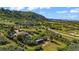 Breathtaking aerial view of a hillside home surrounded by lush trees and greenery on a sunny day at 1380 Oak Valley Rd, Sedalia, CO 80135