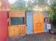 Quaint barn features wooden doors, a wreath, and a humorous sign about 'tiny raptors' at 1380 Oak Valley Rd, Sedalia, CO 80135
