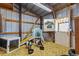 Cozy barn interior featuring hay bedding, wooden beams, and an indoor play area for animals at 1380 Oak Valley Rd, Sedalia, CO 80135
