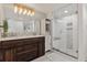 Modern bathroom featuring a glass shower, wood vanity, and stylish lighting at 1380 Oak Valley Rd, Sedalia, CO 80135