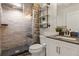 Bathroom features a modern shower, decorative shelves, and a stylish vanity with a sink at 1380 Oak Valley Rd, Sedalia, CO 80135