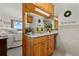 Bright bathroom with granite countertops, natural wood cabinets, and bedroom view at 1380 Oak Valley Rd, Sedalia, CO 80135