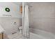 Bright bathroom with tiled walls, a shower-tub combination, and a clean, minimalist design at 1380 Oak Valley Rd, Sedalia, CO 80135