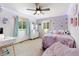 Comfortable bedroom with carpeted floors, curtains, a dresser, and a fluffy bed with decorative pillows and string lights at 1380 Oak Valley Rd, Sedalia, CO 80135