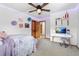 Bright bedroom featuring neutral carpet, an open entry, and a desk area with a computer and decorative accents at 1380 Oak Valley Rd, Sedalia, CO 80135