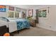 A cozy bedroom with comfortable carpeting, ample natural light, and sports-themed decorations at 1380 Oak Valley Rd, Sedalia, CO 80135