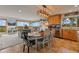 A dining table with rustic chairs adjacent to a kitchen with stainless steel appliances at 1380 Oak Valley Rd, Sedalia, CO 80135