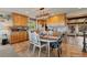 Open kitchen with custom wood cabinetry and eat in dining, perfect for entertaining at 1380 Oak Valley Rd, Sedalia, CO 80135