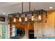 Stylish modern light fixture over kitchen island at 1380 Oak Valley Rd, Sedalia, CO 80135