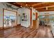 Inviting living area featuring hardwood floors, wooden beams, and a decorative shark hanging on the wall at 1380 Oak Valley Rd, Sedalia, CO 80135