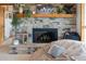Inviting living room featuring a stone fireplace with wooden mantle, decorative accents, and a relaxed ambiance at 1380 Oak Valley Rd, Sedalia, CO 80135