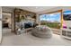 Cozy living room with stone fireplace, plush seating, and picturesque views from a large window at 1380 Oak Valley Rd, Sedalia, CO 80135