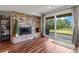 Cozy living room featuring a stone fireplace and a sliding glass door to the backyard at 1380 Oak Valley Rd, Sedalia, CO 80135