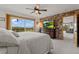 Spacious main bedroom with a stone accent wall, large windows, and access to outdoor balcony at 1380 Oak Valley Rd, Sedalia, CO 80135