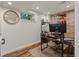 Basement office with hardwood floors and a brick accent wall at 1380 Oak Valley Rd, Sedalia, CO 80135