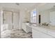Elegant bathroom with double sinks, marble floors, and a glass-enclosed shower at 39886 Floyd St, Elizabeth, CO 80107