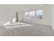 Spacious bedroom with neutral carpet, a doorway to bath and three large windows at 39886 Floyd St, Elizabeth, CO 80107