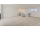 Bright loft featuring neutral carpeting, white walls, and a black metal railing with a white trim at 39886 Floyd St, Elizabeth, CO 80107