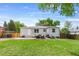 Well-maintained backyard with green grass, patio furniture, a grill, and a fenced perimeter, perfect for outdoor living at 9220 Yucca Way, Thornton, CO 80229
