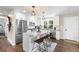 Spacious kitchen with stainless appliances, center island with barstool seating, and modern light fixtures at 9220 Yucca Way, Thornton, CO 80229