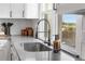 Modern kitchen features a stainless sink, matte black faucet and accessories, and bright natural light at 9220 Yucca Way, Thornton, CO 80229