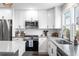 Modern kitchen featuring stainless steel appliances, white cabinets, and sleek countertops at 9220 Yucca Way, Thornton, CO 80229