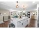 Open floorplan with kitchen island and view of living room with modern decor and natural light at 9220 Yucca Way, Thornton, CO 80229
