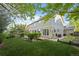 Backyard boasts a lush lawn, mature trees, garden, and a patio for outdoor enjoyment at 7837 Aravon Ct, Lone Tree, CO 80124