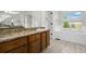 Elegant bathroom showcases granite countertops and a luxurious soaking tub at 7837 Aravon Ct, Lone Tree, CO 80124