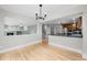 Bright dining area featuring hardwood floors, view to living room, and kitchen area at 7837 Aravon Ct, Lone Tree, CO 80124