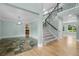 Bright entryway showcases a beautiful staircase with iron railings and a blend of slate and hardwood flooring at 7837 Aravon Ct, Lone Tree, CO 80124