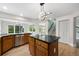 An open concept kitchen with stainless appliances, black granite countertops, and light wood flooring at 7837 Aravon Ct, Lone Tree, CO 80124