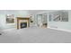 Cozy living room features a fireplace, large windows offering natural light, and neutral carpeting for a warm ambiance at 7837 Aravon Ct, Lone Tree, CO 80124