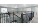 Large loft area with wrought iron railing, neutral color palette, and carpet flooring at 7837 Aravon Ct, Lone Tree, CO 80124
