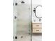 Stylish bathroom with a glass shower, pebble floor, and modern vanity at 121 S Ivy St, Denver, CO 80224