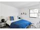 Comfortable bedroom featuring a black frame bed, window, and modern decor at 121 S Ivy St, Denver, CO 80224