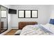 Bright bedroom featuring a modern dresser, black-framed window, and minimalist decor at 121 S Ivy St, Denver, CO 80224