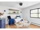 Charming bedroom featuring swing chairs, wood floors, and abundant natural light at 121 S Ivy St, Denver, CO 80224