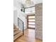 Inviting entryway features a wood front door, accent stone wall, and modern chandelier at 121 S Ivy St, Denver, CO 80224
