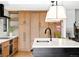 Spacious kitchen featuring stainless steel appliances, a large island, modern lighting and hardwood floors at 121 S Ivy St, Denver, CO 80224