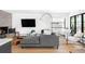 Bright living room features a stone fireplace, a gray sofa, and large windows at 121 S Ivy St, Denver, CO 80224