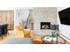 Cozy living area features a stone fireplace, yellow arm chair, and modern furniture at 121 S Ivy St, Denver, CO 80224