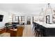 Open-concept living room and kitchen features hardwood floors, modern furniture, and plenty of natural light at 121 S Ivy St, Denver, CO 80224