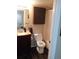 Updated bathroom with a toilet, tub, and dark brown vanity at 3100 S Federal Blvd # 203, Denver, CO 80236