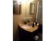 Clean bathroom with dark vanity, single sink, and shower/tub combo at 3100 S Federal Blvd # 203, Denver, CO 80236