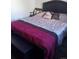 Bedroom with a double bed and dark-colored headboard at 3100 S Federal Blvd # 203, Denver, CO 80236