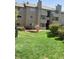 Exterior view of a condo building with landscaping and a pond at 3100 S Federal Blvd # 203, Denver, CO 80236