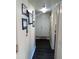 Bright hallway with dark laminate flooring and ample wall space at 3100 S Federal Blvd # 203, Denver, CO 80236