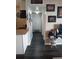 Clean hallway with dark laminate flooring and storage closet at 3100 S Federal Blvd # 203, Denver, CO 80236